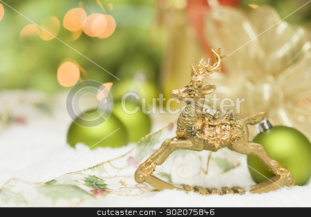 To use this stock image in your creative project, please select the size you need over to the right and click the "Add to Cart" button.
Your downloaded image will come with the Cutcaster watermark removed so don’t worry about the watermark you see on this page. Golden Christmas Reindeer Ornament Among Snow, Bulbs and Ribbon stock photo, Beautiful Golden Christmas Reindeer Ornament Among Snow, Bulbs and Ribbon Against an Abstract Background. by Andy Dean