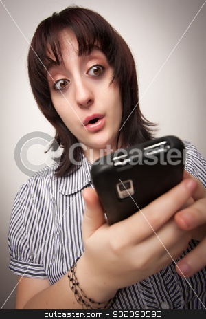To use this stock image in your creative project, please select the size you need over to the right and click the "Add to Cart" button.
Your downloaded image will come with the Cutcaster watermark removed so don’t worry about the watermark you see on this page. Stunned Brunette Woman Using Cell Phone stock photo, Stunned Brunette Woman Using Cell Phone on a Grey Background. by Andy Dean