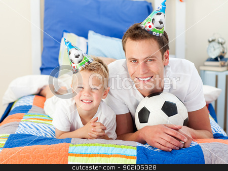 To use this stock image in your creative project, please select the size you need over to the right and click the "Add to Cart" button.
Your downloaded image will come with the Cutcaster watermark removed so don’t worry about the watermark you see on this page. Happy child and his father playing with a soccer ball stock photo, Happy child and his father playing with a soccer ball lying on bed by Wavebreak Media