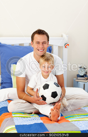 To use this stock image in your creative project, please select the size you need over to the right and click the "Add to Cart" button.
Your downloaded image will come with the Cutcaster watermark removed so don’t worry about the watermark you see on this page. Portrait of a little boy and his father playing with a soccer ba stock photo, Portrait of a little boy and his father playing with a soccer ball sitting on bed by Wavebreak Media
