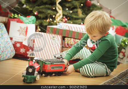 To use this stock image in your creative project, please select the size you need over to the right and click the "Add to Cart" button.
Your downloaded image will come with the Cutcaster watermark removed so don’t worry about the watermark you see on this page. Young Boy Enjoying Christmas Morning Near The Tree stock photo, Cute Young Boy Enjoying Christmas Morning Near The Tree. by Andy Dean