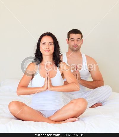 To use this stock image in your creative project, please select the size you need over to the right and click the "Add to Cart" button.
Your downloaded image will come with the Cutcaster watermark removed so don’t worry about the watermark you see on this page. Couple doing yoga in bed stock photo, Young couple doing yoga in bed by Wavebreak Media