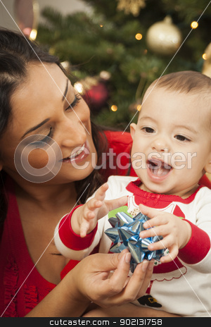 To use this stock image in your creative project, please select the size you need over to the right and click the "Add to Cart" button.
Your downloaded image will come with the Cutcaster watermark removed so don’t worry about the watermark you see on this page. Ethnic Woman With Her Mixed Race Baby Christmas Portrait stock photo, Young Attractive Ethnic Woman With Her Newborn Mixed Race Baby Near The Christmas Tree. by Andy Dean