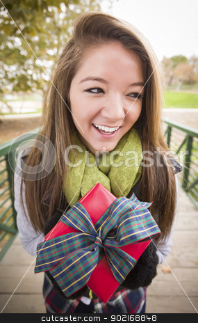 To use this stock image in your creative project, please select the size you need over to the right and click the "Add to Cart" button.
Your downloaded image will come with the Cutcaster watermark removed so don’t worry about the watermark you see on this page. Pretty Woman with Wrapped Gift with Bow Outside stock photo, Pretty Festive Smiling Woman with Wrapped Gift with Bow Outside. by Andy Dean