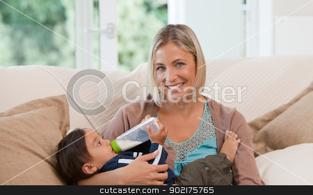 To use this stock image in your creative project, please select the size you need over to the right and click the "Add to Cart" button.
Your downloaded image will come with the Cutcaster watermark removed so don’t worry about the watermark you see on this page. Mother giving a bottle of milk to her son stock photo, Mother giving a bottle of milk to her son at home by Wavebreak Media