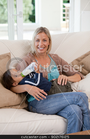 To use this stock image in your creative project, please select the size you need over to the right and click the "Add to Cart" button.
Your downloaded image will come with the Cutcaster watermark removed so don’t worry about the watermark you see on this page. Mother giving a bottle of milk to her son stock photo, Mother giving a bottle of milk to her son at home by Wavebreak Media