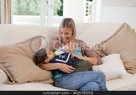 To use this stock image in your creative project, please select the size you need over to the right and click the "Add to Cart" button.
Your downloaded image will come with the Cutcaster watermark removed so don’t worry about the watermark you see on this page. Mother giving a bottle of milk to her son stock photo, Mother giving a bottle of milk to her son at home by Wavebreak Media