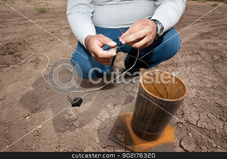 To use this stock image in your creative project, please select the size you need over to the right and click the "Add to Cart" button.
Your downloaded image will come with the Cutcaster watermark removed so don’t worry about the watermark you see on this page. EFX Expert Setting Up Remote Device stock photo, Close up of motion picture pyrotechnic expert working with wires by Scott Griessel