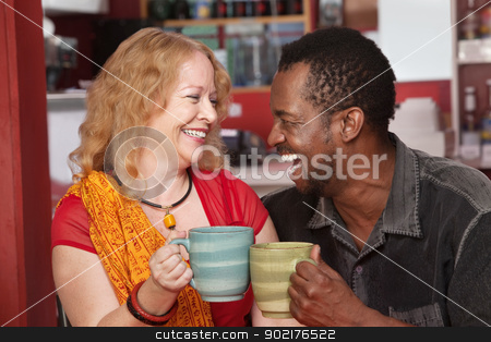 To use this stock image in your creative project, please select the size you need over to the right and click the "Add to Cart" button.
Your downloaded image will come with the Cutcaster watermark removed so don’t worry about the watermark you see on this page. Smiling Mixed Couple Laughing stock photo, Happy Black man and European woman laughing together in cafe by Scott Griessel