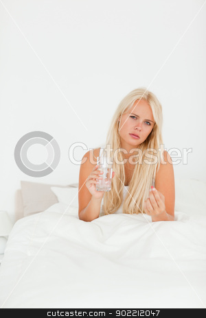 To use this stock image in your creative project, please select the size you need over to the right and click the "Add to Cart" button.
Your downloaded image will come with the Cutcaster watermark removed so don’t worry about the watermark you see on this page. Portrait of a sick woman taking her medication stock photo, Portrait of a sick woman taking her medication in her bedroom by Wavebreak Media