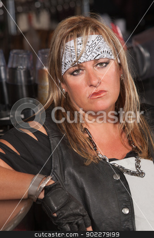 To use this stock image in your creative project, please select the size you need over to the right and click the "Add to Cart" button.
Your downloaded image will come with the Cutcaster watermark removed so don’t worry about the watermark you see on this page. Serious Female Thug Leaning Back stock photo, Serious woman in motorcycle gang jacket leaning on counter by Scott Griessel