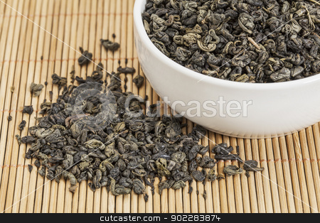 To use this stock image in your creative project, please select the size you need over to the right and click the "Add to Cart" button.
Your downloaded image will come with the Cutcaster watermark removed so don’t worry about the watermark you see on this page. gunpowder green tea stock photo, loose leaf gunpowder green tea in a white china cup and spilled over bamboo mat by Marek Uliasz