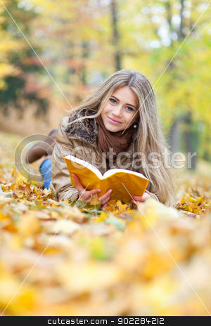 To use this stock image in your creative project, please select the size you need over to the right and click the "Add to Cart" button.
Your downloaded image will come with the Cutcaster watermark removed so don’t worry about the watermark you see on this page. Young woman reading lying on leaves stock photo, Beautiful woman in a park, reading and smiling by tristanbm
