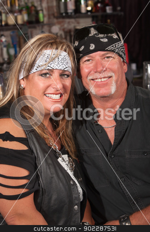 To use this stock image in your creative project, please select the size you need over to the right and click the "Add to Cart" button.
Your downloaded image will come with the Cutcaster watermark removed so don’t worry about the watermark you see on this page. Smiling Couple in Bandannas stock photo, Handsome middle aged couple in leather and bandanna in bar by Scott Griessel