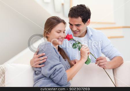To use this stock image in your creative project, please select the size you need over to the right and click the "Add to Cart" button.
Your downloaded image will come with the Cutcaster watermark removed so don’t worry about the watermark you see on this page. Young man offering a rose to his fiance stock photo, Young man offering a rose to his fiance in their living room by Wavebreak Media