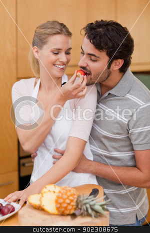 To use this stock image in your creative project, please select the size you need over to the right and click the "Add to Cart" button.
Your downloaded image will come with the Cutcaster watermark removed so don’t worry about the watermark you see on this page. Portrait of a charming couple eating fruits stock photo, Portrait of a charming couple eating fruits in their kitchen by Wavebreak Media