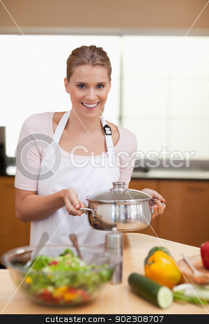 To use this stock image in your creative project, please select the size you need over to the right and click the "Add to Cart" button.
Your downloaded image will come with the Cutcaster watermark removed so don’t worry about the watermark you see on this page. Portrait of a woman holding a sauce pan stock photo, Portrait of a woman holding a sauce pan in her kitchen by Wavebreak Media