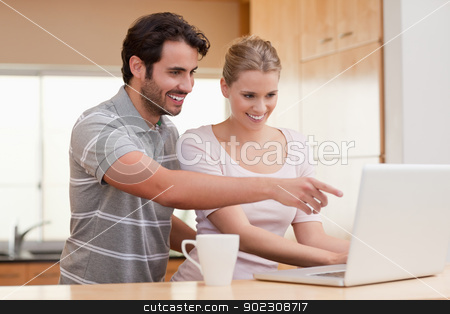 To use this stock image in your creative project, please select the size you need over to the right and click the "Add to Cart" button.
Your downloaded image will come with the Cutcaster watermark removed so don’t worry about the watermark you see on this page. Couple using a notebook while having coffee stock photo, Couple using a notebook while having coffee in their kitchen by Wavebreak Media