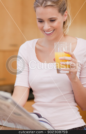 To use this stock image in your creative project, please select the size you need over to the right and click the "Add to Cart" button.
Your downloaded image will come with the Cutcaster watermark removed so don’t worry about the watermark you see on this page. Portrait of a young woman reading the news while drinking juice stock photo, Portrait of a young woman reading the news while drinking juice in her kitchen by Wavebreak Media