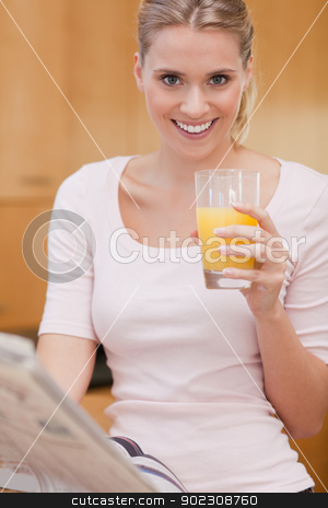 To use this stock image in your creative project, please select the size you need over to the right and click the "Add to Cart" button.
Your downloaded image will come with the Cutcaster watermark removed so don’t worry about the watermark you see on this page. Portrait of a cute woman reading the news while drinking juice stock photo, Portrait of a cute woman reading the news while drinking juice in her kitchen by Wavebreak Media