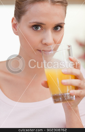 To use this stock image in your creative project, please select the size you need over to the right and click the "Add to Cart" button.
Your downloaded image will come with the Cutcaster watermark removed so don’t worry about the watermark you see on this page. Portrait of a woman drinking juice stock photo, Portrait of a woman drinking juice in her kitchen by Wavebreak Media