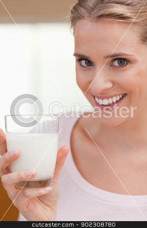 To use this stock image in your creative project, please select the size you need over to the right and click the "Add to Cart" button.
Your downloaded image will come with the Cutcaster watermark removed so don’t worry about the watermark you see on this page. Portrait of a young woman drinking a glass of milk stock photo, Portrait of a young woman drinking a glass of milk in her kitchen by Wavebreak Media
