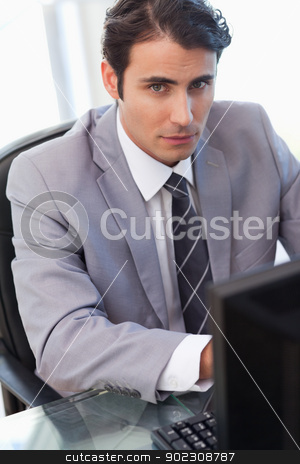 To use this stock image in your creative project, please select the size you need over to the right and click the "Add to Cart" button.
Your downloaded image will come with the Cutcaster watermark removed so don’t worry about the watermark you see on this page. Portrait of a serious businessman working with a computer stock photo, Portrait of a serious businessman working with a computer in his office by Wavebreak Media