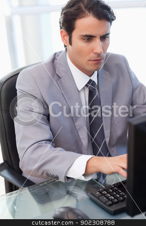To use this stock image in your creative project, please select the size you need over to the right and click the "Add to Cart" button.
Your downloaded image will come with the Cutcaster watermark removed so don’t worry about the watermark you see on this page. Portrait of a focused businessman working with a computer stock photo, Portrait of a focused businessman working with a computer in his office by Wavebreak Media