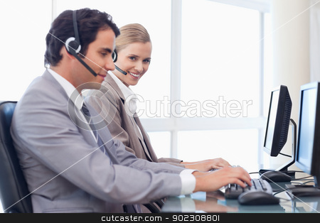 To use this stock image in your creative project, please select the size you need over to the right and click the "Add to Cart" button.
Your downloaded image will come with the Cutcaster watermark removed so don’t worry about the watermark you see on this page. Happy operators using a computer stock photo, Happy operators using a computer in a call center by Wavebreak Media