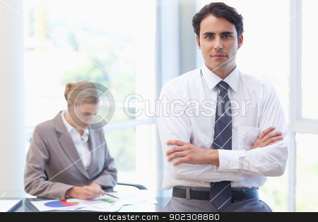 To use this stock image in your creative project, please select the size you need over to the right and click the "Add to Cart" button.
Your downloaded image will come with the Cutcaster watermark removed so don’t worry about the watermark you see on this page. Businessman posing while his colleague is working stock photo, Businessman posing while his colleague is working in a meeting room by Wavebreak Media