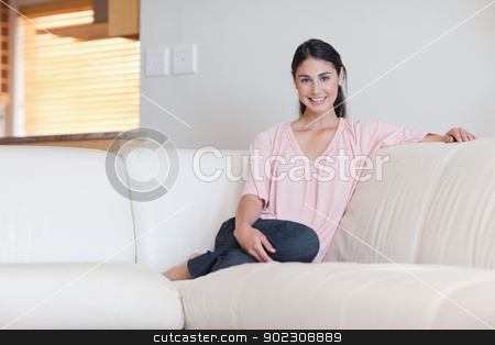 To use this stock image in your creative project, please select the size you need over to the right and click the "Add to Cart" button.
Your downloaded image will come with the Cutcaster watermark removed so don’t worry about the watermark you see on this page. Woman sitting on a couch stock photo, Woman sitting on a couch in her living room by Wavebreak Media