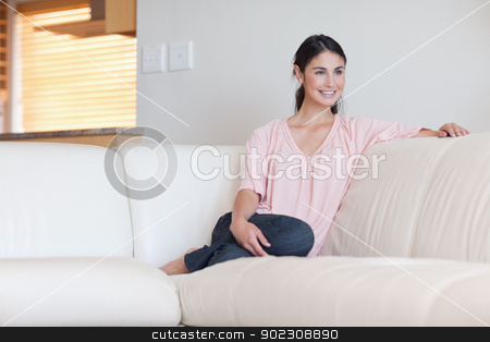 To use this stock image in your creative project, please select the size you need over to the right and click the "Add to Cart" button.
Your downloaded image will come with the Cutcaster watermark removed so don’t worry about the watermark you see on this page. Woman sitting on a sofa stock photo, Woman sitting on a sofa in her living room by Wavebreak Media