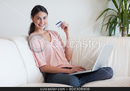To use this stock image in your creative project, please select the size you need over to the right and click the "Add to Cart" button.
Your downloaded image will come with the Cutcaster watermark removed so don’t worry about the watermark you see on this page. Joyful woman shopping online stock photo, Joyful woman shopping online in her living room by Wavebreak Media