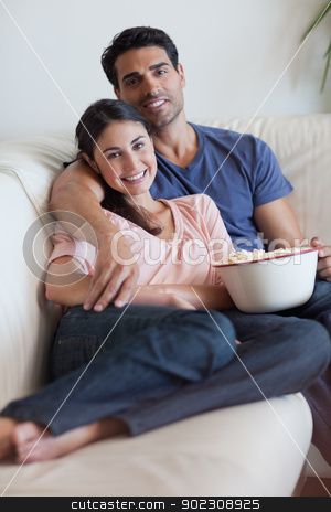 To use this stock image in your creative project, please select the size you need over to the right and click the "Add to Cart" button.
Your downloaded image will come with the Cutcaster watermark removed so don’t worry about the watermark you see on this page. Portrait of a smiling couple watching television while eating po stock photo, Portrait of a smiling couple watching television while eating popcorn in their living room by Wavebreak Media