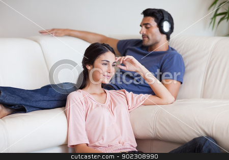 To use this stock image in your creative project, please select the size you need over to the right and click the "Add to Cart" button.
Your downloaded image will come with the Cutcaster watermark removed so don’t worry about the watermark you see on this page. Woman watching TV while her husband is listening to music stock photo, Woman watching TV while her husband is listening to music in their living room by Wavebreak Media