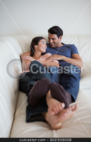 To use this stock image in your creative project, please select the size you need over to the right and click the "Add to Cart" button.
Your downloaded image will come with the Cutcaster watermark removed so don’t worry about the watermark you see on this page. Portrait of a young couple lying on a sofa stock photo, Portrait of a young couple lying on a sofa while looking at each other by Wavebreak Media