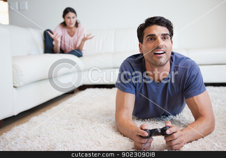 To use this stock image in your creative project, please select the size you need over to the right and click the "Add to Cart" button.
Your downloaded image will come with the Cutcaster watermark removed so don’t worry about the watermark you see on this page. Man playing video games while his fiance is getting mad at him stock photo, Man playing video games while his fiance is getting mad at him in their living room by Wavebreak Media
