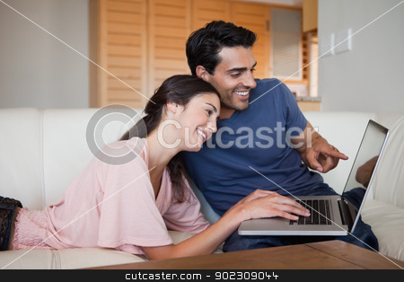 To use this stock image in your creative project, please select the size you need over to the right and click the "Add to Cart" button.
Your downloaded image will come with the Cutcaster watermark removed so don’t worry about the watermark you see on this page. Lovely young couple using a laptop stock photo, Lovely young couple using a laptop in their living room by Wavebreak Media