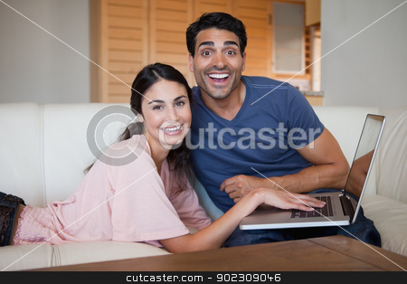 To use this stock image in your creative project, please select the size you need over to the right and click the "Add to Cart" button.
Your downloaded image will come with the Cutcaster watermark removed so don’t worry about the watermark you see on this page. Laughing young couple using a notebook stock photo, Laughing young couple using a notebook in their living room by Wavebreak Media