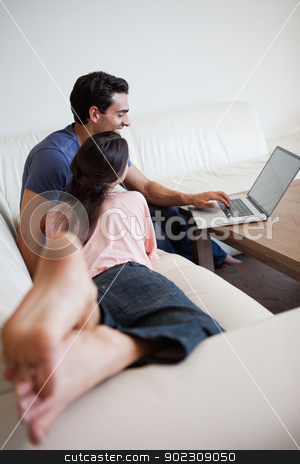 To use this stock image in your creative project, please select the size you need over to the right and click the "Add to Cart" button.
Your downloaded image will come with the Cutcaster watermark removed so don’t worry about the watermark you see on this page. Above view of a couple using a laptop stock photo, Above view of a couple using a laptop in their living room by Wavebreak Media