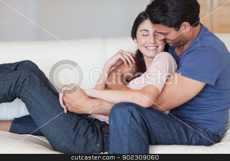 To use this stock image in your creative project, please select the size you need over to the right and click the "Add to Cart" button.
Your downloaded image will come with the Cutcaster watermark removed so don’t worry about the watermark you see on this page. Man kissing his fiance in the neck stock photo, Man kissing his fiance in the neck in their living room by Wavebreak Media