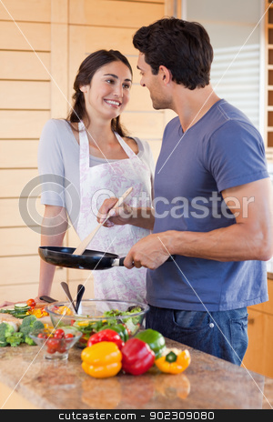 To use this stock image in your creative project, please select the size you need over to the right and click the "Add to Cart" button.
Your downloaded image will come with the Cutcaster watermark removed so don’t worry about the watermark you see on this page. Portrait of a beautiful couple cooking with a pan stock photo, Portrait of a beautiful couple cooking with a pan in their kitchen by Wavebreak Media