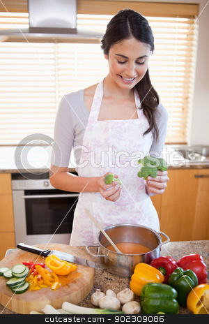To use this stock image in your creative project, please select the size you need over to the right and click the "Add to Cart" button.
Your downloaded image will come with the Cutcaster watermark removed so don’t worry about the watermark you see on this page. Portrait of a woman cooking a soup stock photo, Portrait of a woman cooking a soup in her kitchen by Wavebreak Media