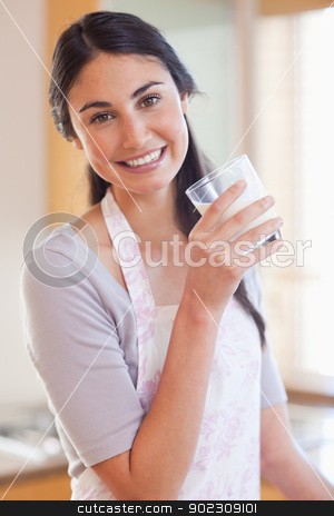 To use this stock image in your creative project, please select the size you need over to the right and click the "Add to Cart" button.
Your downloaded image will come with the Cutcaster watermark removed so don’t worry about the watermark you see on this page. Portrait of a beautiful woman drinking milk stock photo, Portrait of a beautiful woman drinking milk in her kitchen by Wavebreak Media
