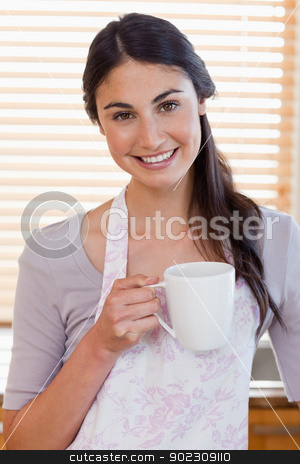 To use this stock image in your creative project, please select the size you need over to the right and click the "Add to Cart" button.
Your downloaded image will come with the Cutcaster watermark removed so don’t worry about the watermark you see on this page. Portrait of a woman holding a cup of coffee stock photo, Portrait of a woman holding a cup of coffee in her kitchen by Wavebreak Media