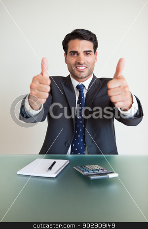 To use this stock image in your creative project, please select the size you need over to the right and click the "Add to Cart" button.
Your downloaded image will come with the Cutcaster watermark removed so don’t worry about the watermark you see on this page. Portrait of an accountant with the thumbs up stock photo, Portrait of an accountant with the thumbs up in his office by Wavebreak Media