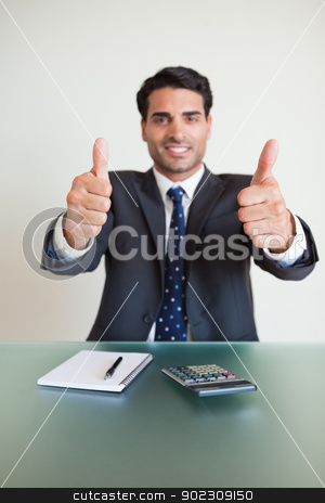 To use this stock image in your creative project, please select the size you need over to the right and click the "Add to Cart" button.
Your downloaded image will come with the Cutcaster watermark removed so don’t worry about the watermark you see on this page. Portrait of a young accountant with the thumbs up stock photo, Portrait of a young accountant with the thumbs up in his office by Wavebreak Media