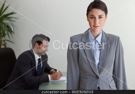To use this stock image in your creative project, please select the size you need over to the right and click the "Add to Cart" button.
Your downloaded image will come with the Cutcaster watermark removed so don’t worry about the watermark you see on this page. Gorgeous businesswoman posing while her colleague is working stock photo, Gorgeous businesswoman posing while her colleague is working in an office by Wavebreak Media