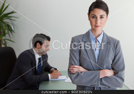 To use this stock image in your creative project, please select the size you need over to the right and click the "Add to Cart" button.
Your downloaded image will come with the Cutcaster watermark removed so don’t worry about the watermark you see on this page. Professional businesswoman posing while her colleague is working stock photo, Professional businesswoman posing while her colleague is working in an office by Wavebreak Media