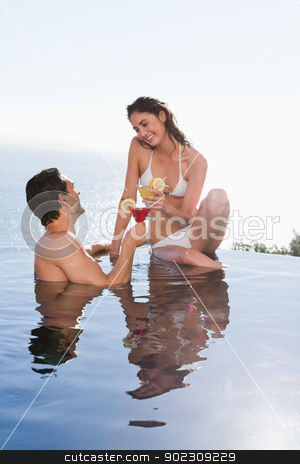 To use this stock image in your creative project, please select the size you need over to the right and click the "Add to Cart" button.
Your downloaded image will come with the Cutcaster watermark removed so don’t worry about the watermark you see on this page. Portrait of a young couple having a cocktail stock photo, Portrait of a young couple having a cocktail in a swimming pool by Wavebreak Media